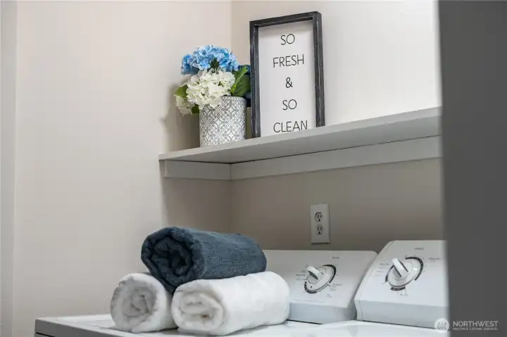 A convenient shelf above provides storage space for detergent and cleaning supplies.