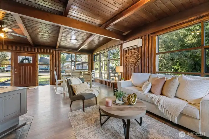 Living room with wood stove and so many windows to let the sunshine in.
