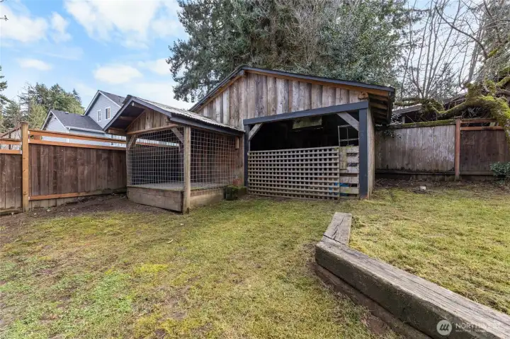 Toward the back of the lot is a shed and chicken coup