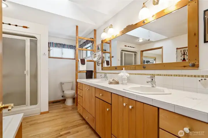 primary bath the other direction showing skylight, shower and more of the creative artistry of the owners.