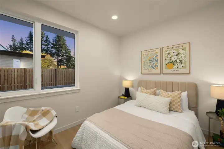 Quiet, well-appointed bedroom highlighting the home’s contemporary aesthetic and natural light.