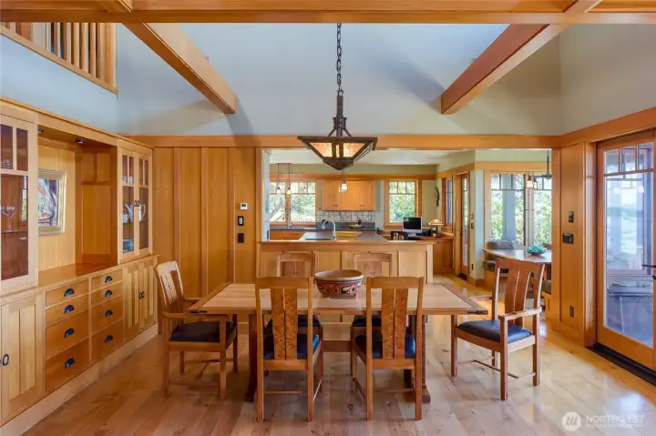 Dining area has built-in buffet with glass doors and French doors to the sunny stone patio.