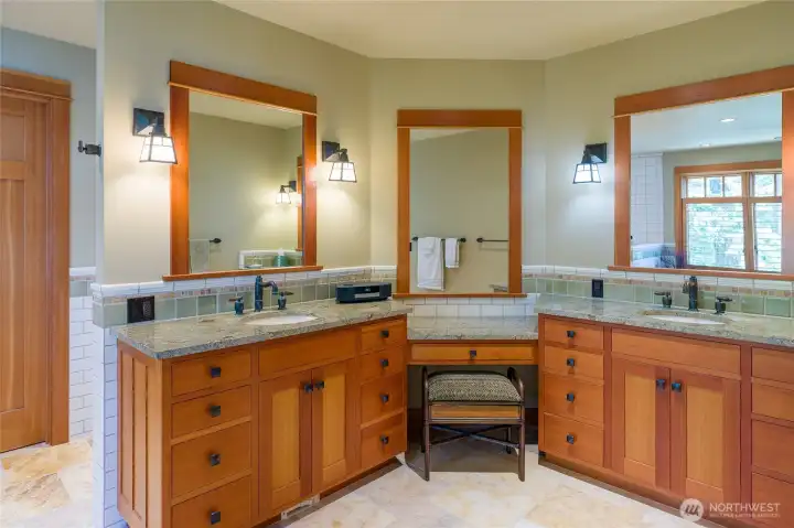 Main floor primary bathroom with double sinks and separate makeup area.
