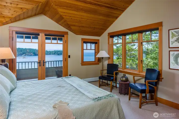 Second primary bedroom includes a covered deck out the French doors.