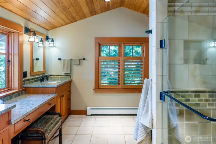 Second primary bathroom with double sinks and tile shower.