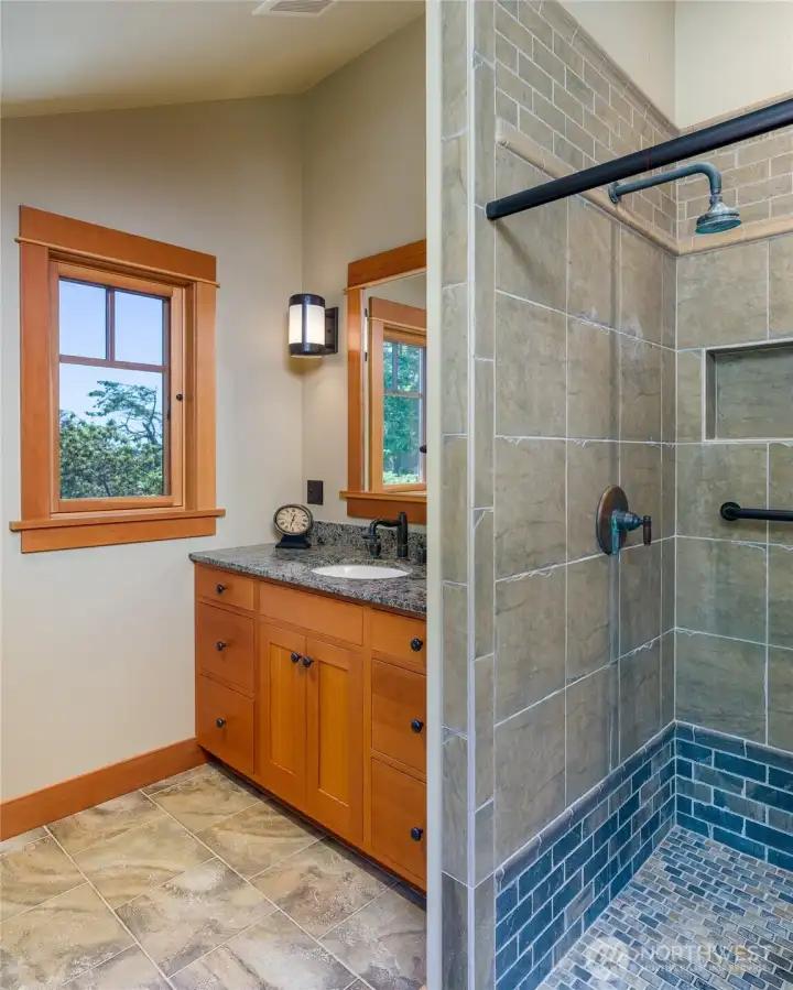Bathroom for third bedroom has single sink and tile shower.