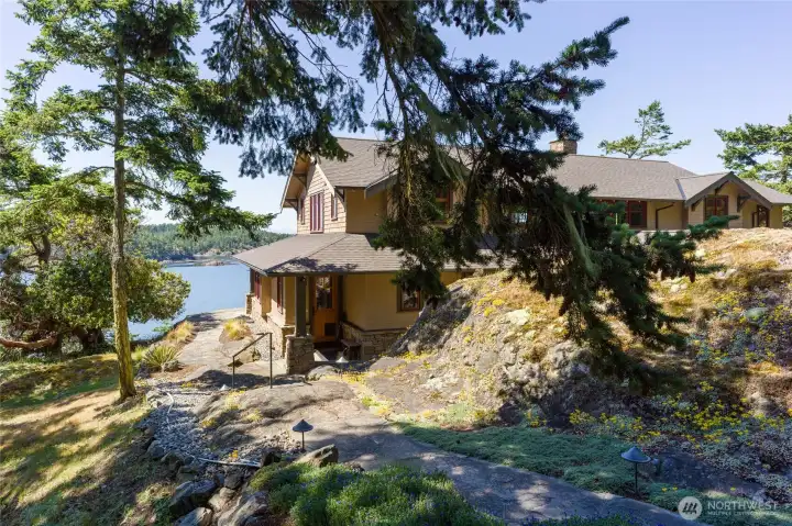Smaller stone path leads to the back door which enters the kitchen.