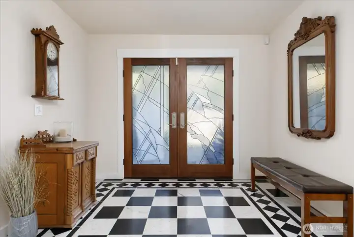 Home's Front Entry is highlighted by the beautifully-designed Marble Floor, and the specially designed lead-windowed front doors