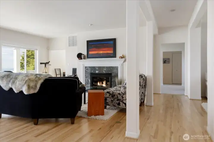 Great Room-style Living Room, Dining Room & Kitchen area on the 2nd level. Hickory flooring, propane gas fireplace with slate surround and built-in WIFI stereo speakers. French doors out to the 2nd level deck with views of the Sound & mountains