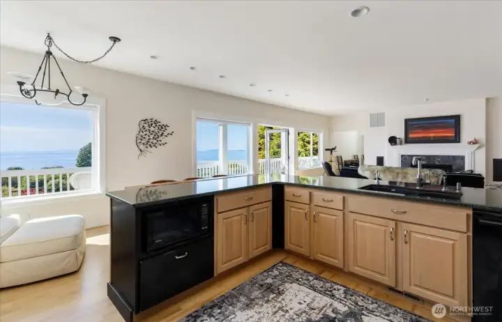 Plenty of cabinetry and Instant "Hot" Water on kitchen sink faucet. Sitting area next to kitchen with views out to the Sound & mountains.