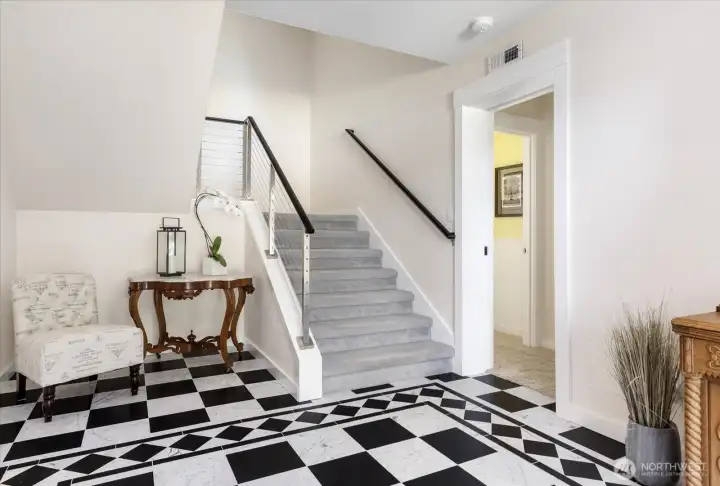 Marbled Front Entry with stairs to the upper levels (2nd & 3rd floors), and the doorway to the Guest Room and Office area. New Metal Stair railings for all three floors installed in 2016. New Gray carpeting on the 2nd & 3rd floors installed in 2017.