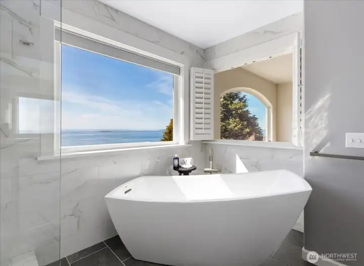 Large Contemporary free-standing Soaking Tub with views out to the water & mountains. Notice the Marble walls which is the entry to Walk-in shower.