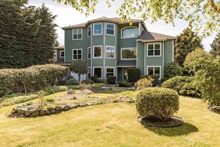 The home and front gardens are hidden from view by the surrounding fir trees, which allows for more privacy from the roadway. In 2016, all new windows & doors were replaced, along with new Cement-planked siding on the Eastside of the home.