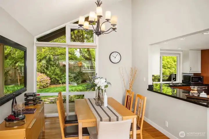 Floor to ceiling windows overlook the park-like grounds