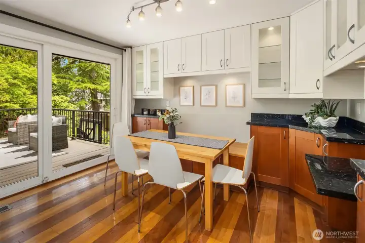 Breakfast nook offers built-in storage and sliding glass doors that open to a newer trex deck