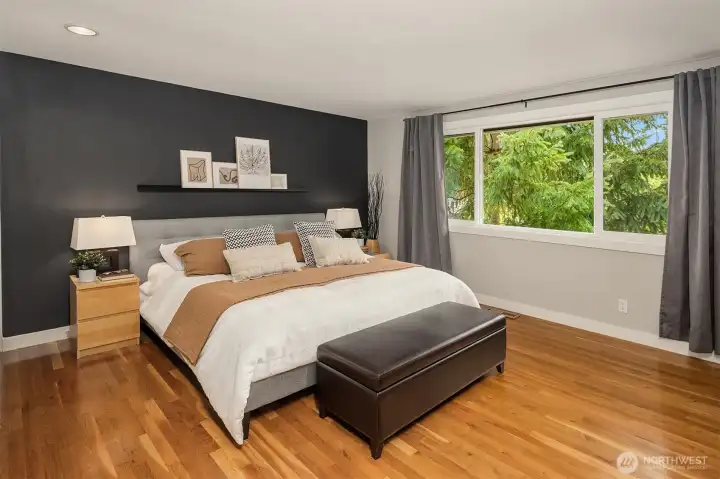 Spacious primary suite with accent wall and dual closets