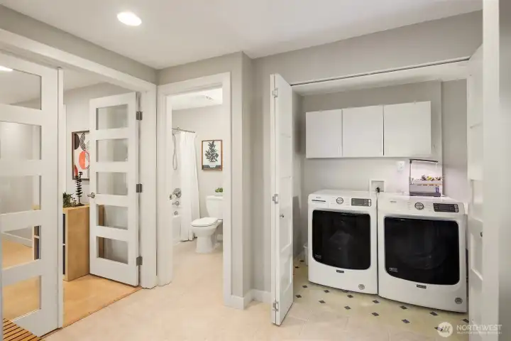 Lower level laundry room and full bath. Recreation room with full kitchen, office and storage space through the double doors to the left