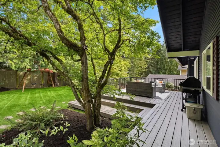 The deck runs the full length of the home with plenty of space to grill, dine or relax