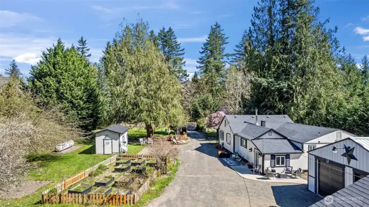 Partial Aerial View of driveway which shows Shop, House, Well house, and raised garden area!