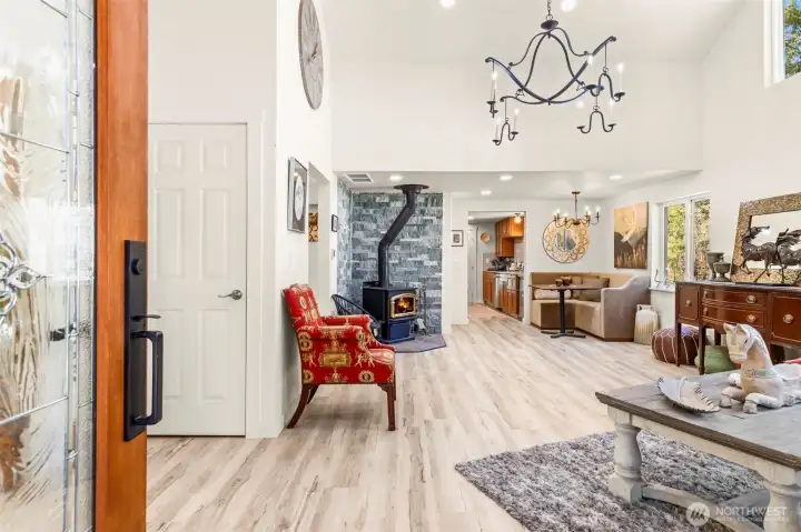 Enter the front door into living room with Cathedral ceilings, woodstove, and breakfast nook!
