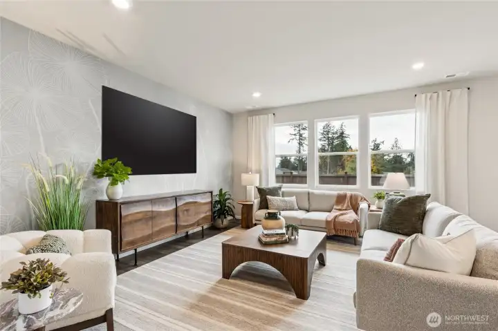 Great room with large picture windows overlooking the back yard.  Finishes and options will vary.