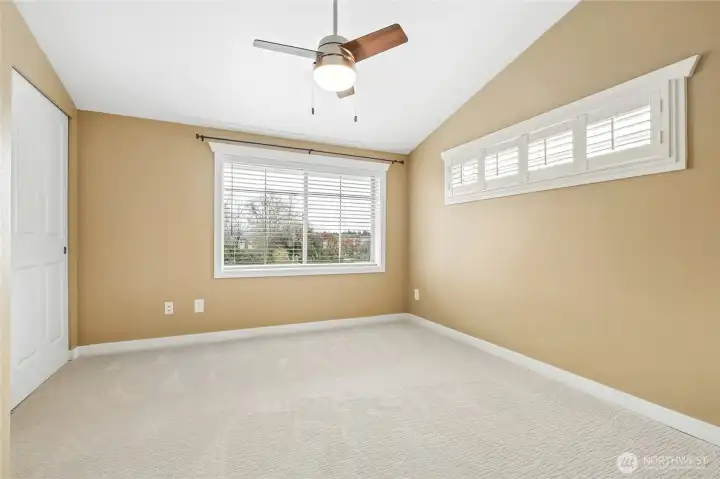 Large primary bedroom with vaulted ceiling, easily accommodates a King bed.