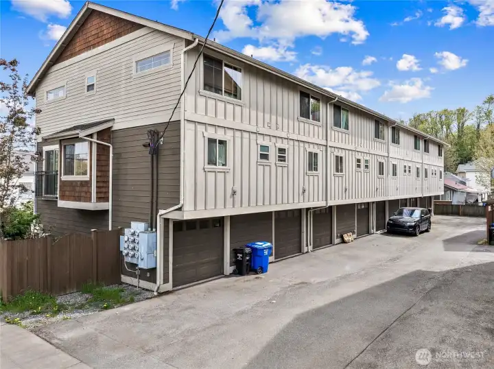 Entry from the main road. Unit is all the way to the right, which allows space for several extra cars to park behind the home next to the fence