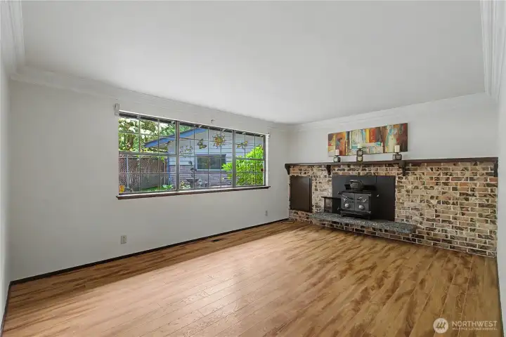 Front living room with wood stove.  The exterior access to the wood box makes it easy to keep the floors clean.