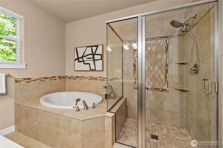 You'll appreciate the luxurious custom tile details around the tub as well as the inlay and corner shelving.