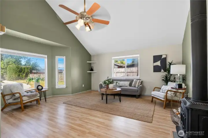 Vaulted ceilings and oversized windows fill the living room with natural light and create an open, airy atmosphere. Vaulted ceilings and oversized windows fill the living room with natural light and create an open, airy atmosphere.