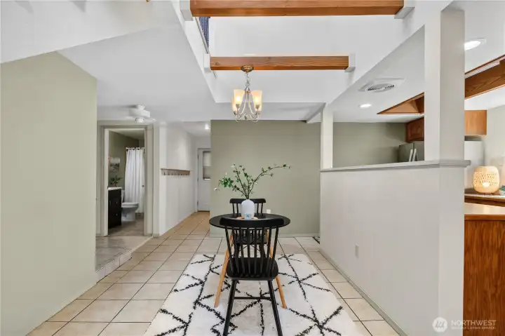 Enjoy an open-concept layout where the dining area flows naturally into the kitchen while exposed wood beams add architectural character. Enjoy an open-concept layout where the dining area flows naturally into the kitchen while exposed wood beams add architectural character.