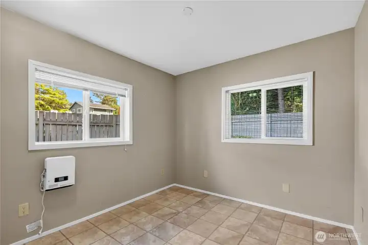 Main-level third bedroom features large windows, abundant natural light, and flexibility for guests, hobbies, or a home office. Main-level third bedroom features large windows, abundant natural light, and flexibility for guests, hobbies, or a home office.