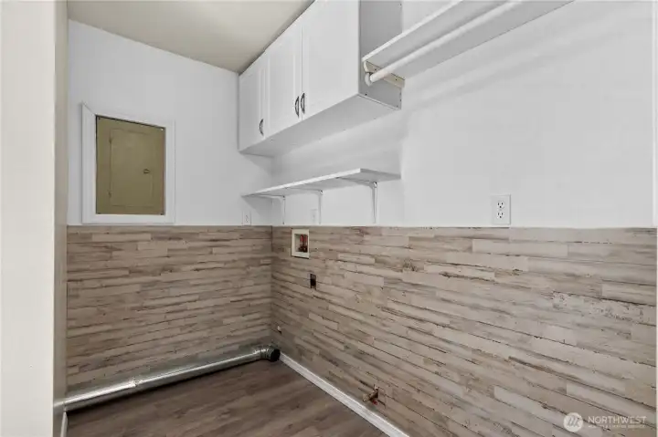Dedicated laundry room with upper cabinetry, open shelving, hanging space, and room to keep household tasks organized. Dedicated laundry room with upper cabinetry, open shelving, hanging space, and room to keep household tasks organized.