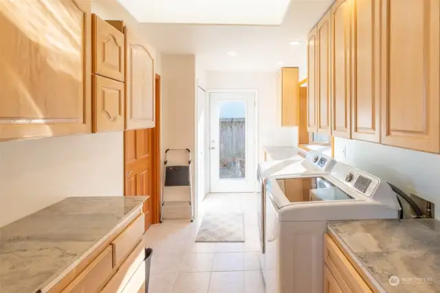 Large Utility room exits to south of home. Special area for a chest freezer that rools under counter. Lots of counter space and pantry cupboards/storage.