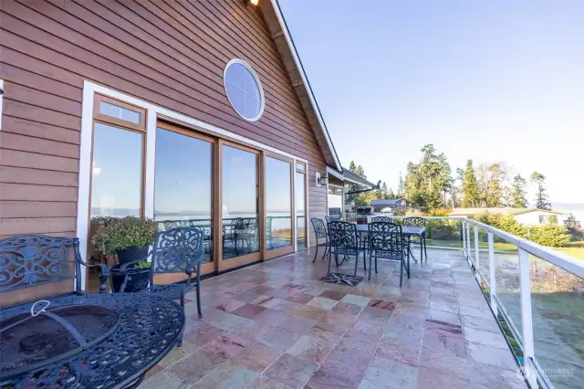 Expansive view deck with tile and view of Port Susan, the Cascades through railing.
