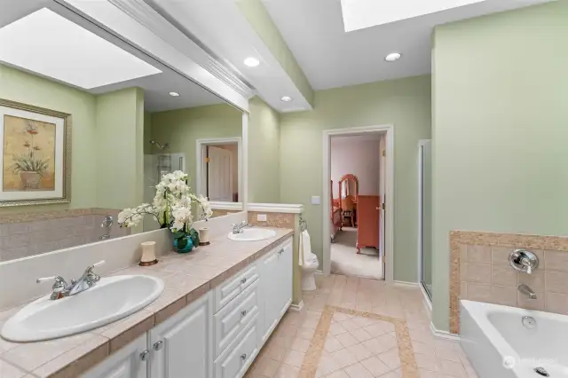 Hall bathroom also features dual sinks along with custom tile & wood work.