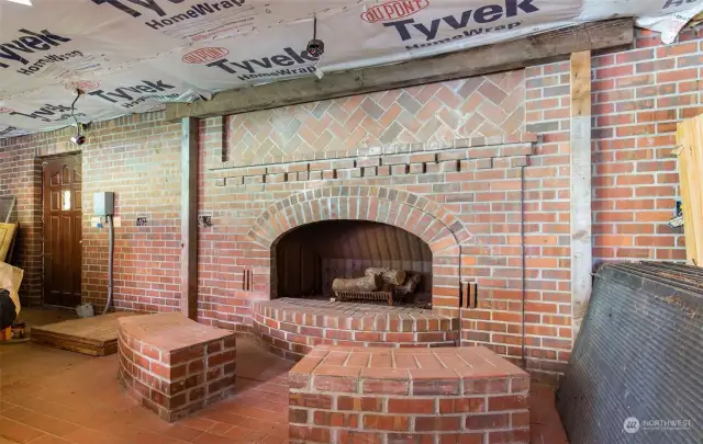 Beautiful Brick fireplace next to the indoor pool