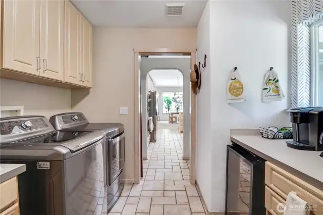 large utility room with custom coffee/tea bar  & mini fridge & pull out ironing board