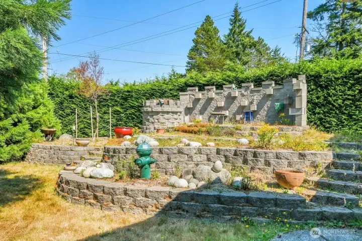 The Castle. Custom built stone garden area with elevated seating. Come and check out the plantings.