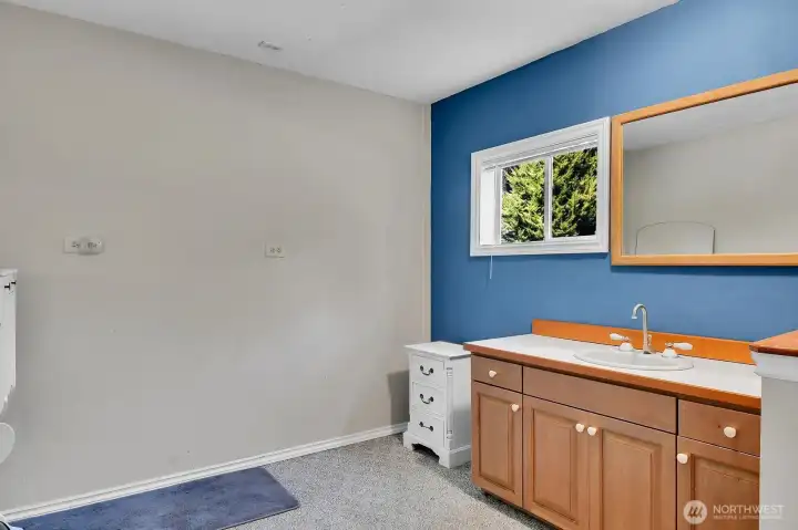 Half bathroom in the garage with attached finished room.
