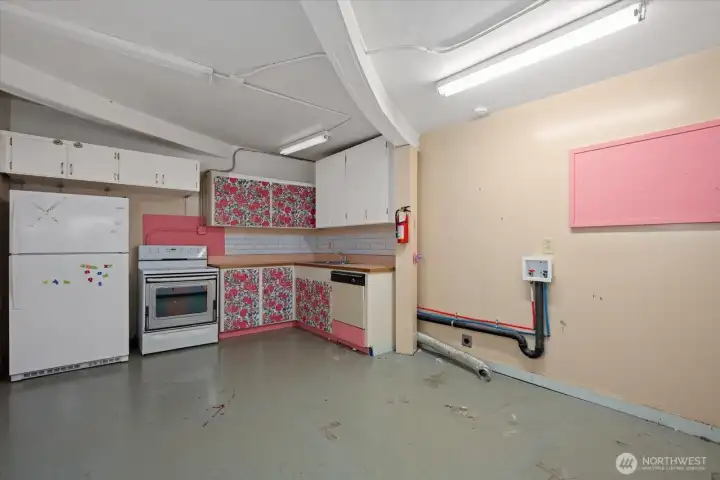 Kitchen in lower level offers fridge, stove, sink, dishwasher and utility hook ups.
