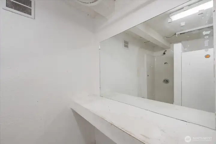 Reflection shows shower stall in lower level 3/4 bath.