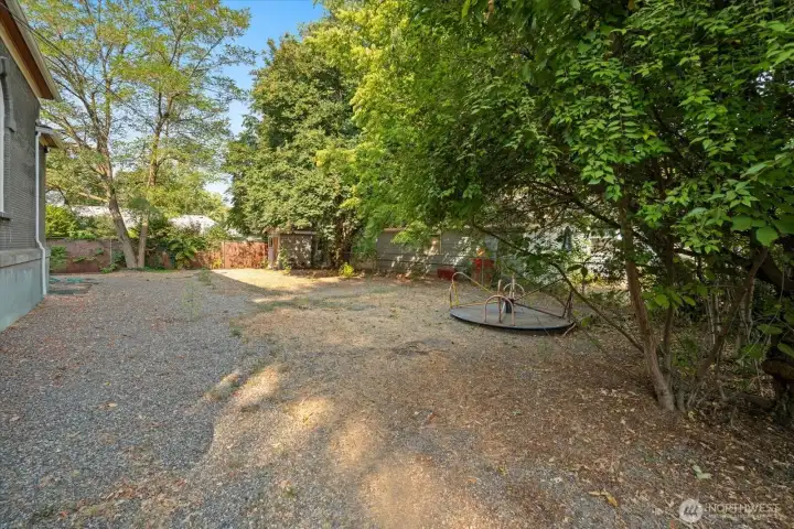 Back yard of church used as playground area and parking area.