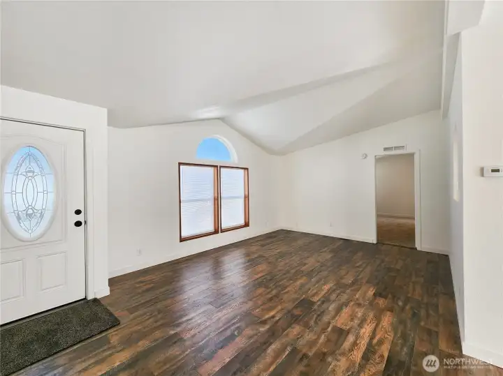 Light-filled main living area with new flooring and a welcoming layout—perfect for relaxing or entertaining guests.
