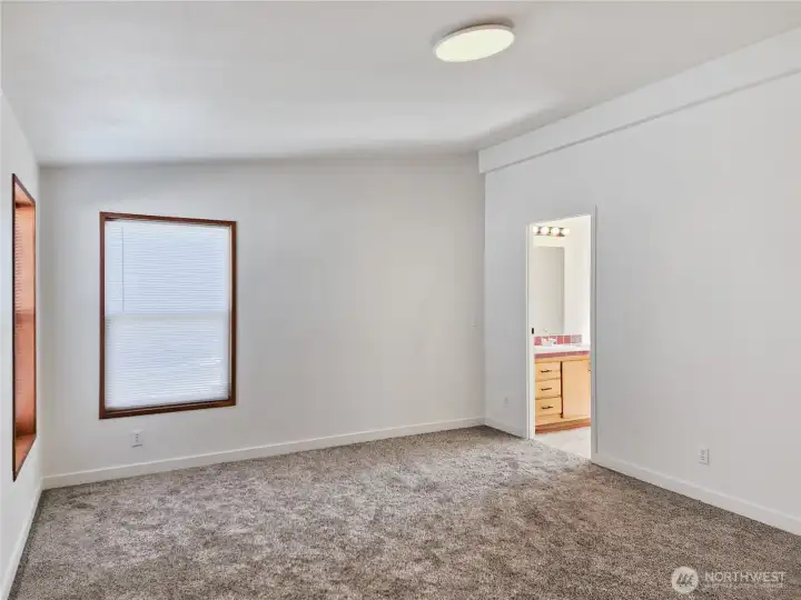 Comfortable primary suite offering privacy, generous closet space, and natural light—an ideal place to unwind.