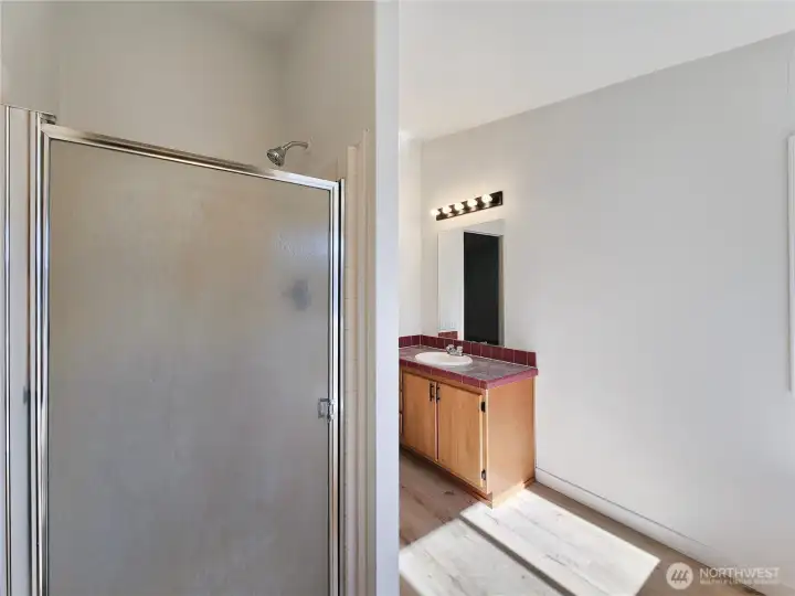 Spacious primary bath featuring dual sinks, separate shower, and a luxurious jetted soaking tub—your own private retreat.