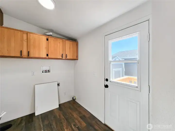 Functional laundry room with added storage and exterior access—ideal for keeping things tidy after outdoor activities.