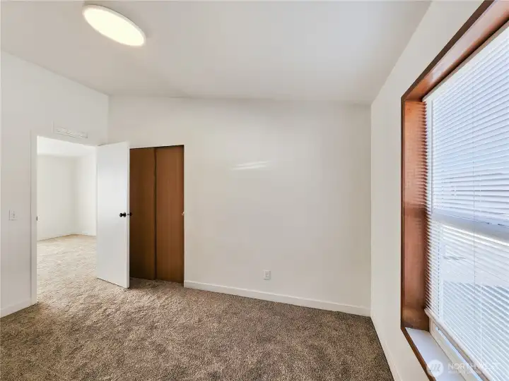 Bright and inviting guest or flex room—perfect for a home office or creative space.