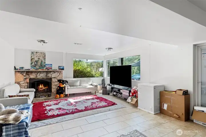 Downstairs recently updated family room with beautiful stone fireplace