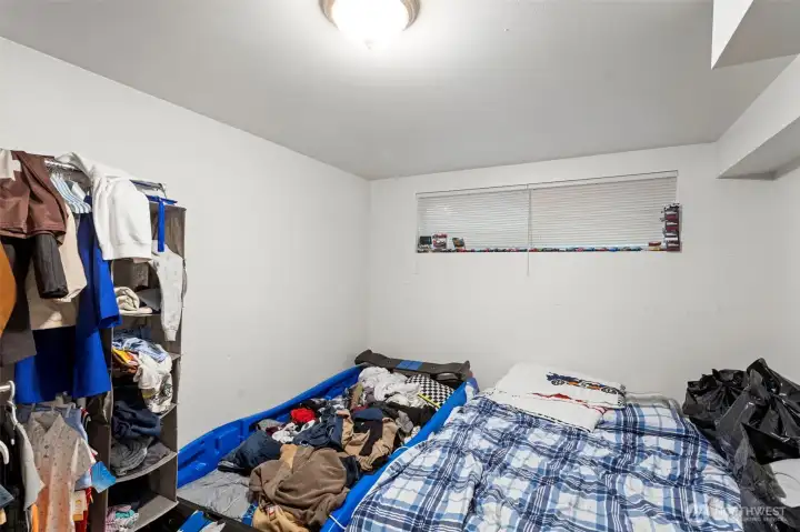 Downstairs bedroom with updated flooring and fresh paint.